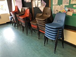 Plastic Chairs - stored at end of Hall